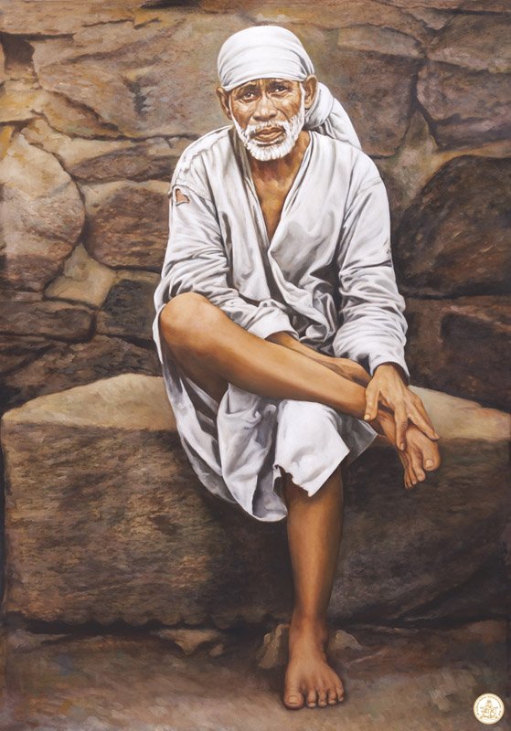 Sai Baba seated on stone