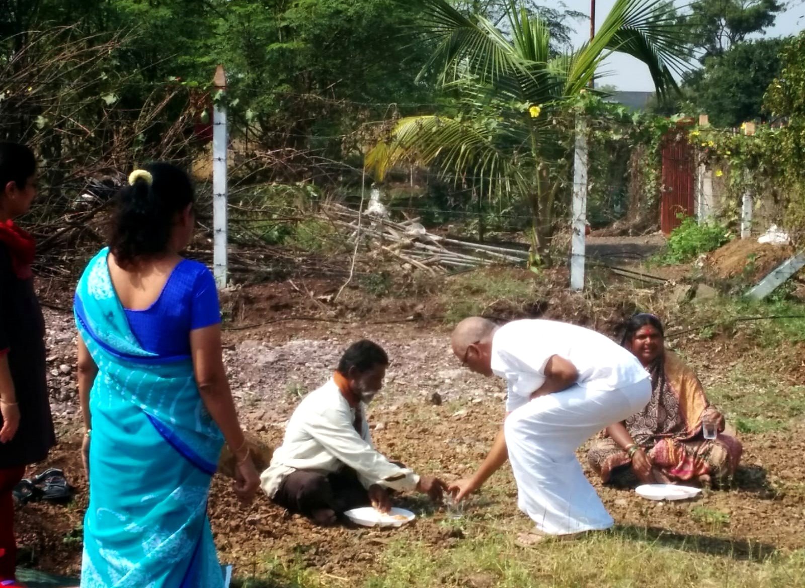 Akshaya Peeth community members taking part in a planting ceremony
